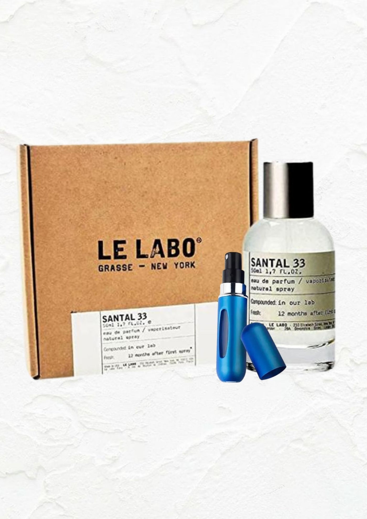 Le Labo Santal 33 eau de parfum bottle with packaging and blue travel spray by ALESANDIE PARFUMS